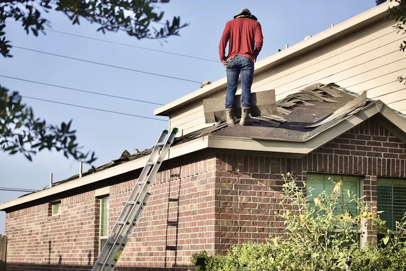 Professional roofer working on a residential roof in Beechwood Trails